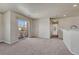 Bright living room featuring a sliding door to a balcony and neutral carpet at 12833 Mayfair Way # F, Englewood, CO 80112