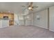 Bright living room with neutral carpeting and a partial view of the kitchen at 12833 Mayfair Way # F, Englewood, CO 80112