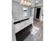 Bathroom with a mirror, wooden floors, vanity, and modern lighting fixture at 2639 S Xanadu Way # B, Aurora, CO 80014
