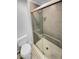 Bathroom featuring a toilet, shower with a glass door, and tiled flooring at 2639 S Xanadu Way # B, Aurora, CO 80014