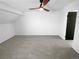 Upstairs bedroom features neutral carpeting, ceiling fan, and newly painted white walls at 2639 S Xanadu Way # B, Aurora, CO 80014