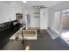 Modern kitchen features black countertops, stainless steel appliances, and sleek white cabinetry at 2639 S Xanadu Way # B, Aurora, CO 80014