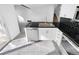 Bright kitchen boasts stainless steel appliances, white cabinets, and modern tile flooring at 2639 S Xanadu Way # B, Aurora, CO 80014