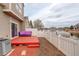 Red deck and purple couch in backyard with water view at 15555 E 40Th Ave # 30, Denver, CO 80239