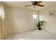 Neutral bedroom with ceiling fan and window at 15555 E 40Th Ave # 30, Denver, CO 80239