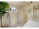 Comfortable bedroom with soft carpet, a large window, and a glimpse into the adjacent hallway at 15555 E 40Th Ave # 30, Denver, CO 80239