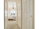 Hallway view of a well-lit bedroom featuring a large window and comfortable furnishings at 15555 E 40Th Ave # 30, Denver, CO 80239