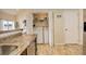 Convenient laundry area with a washer, dryer, and storage shelves easily accessible from the kitchen at 15555 E 40Th Ave # 30, Denver, CO 80239