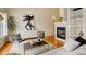 Cozy living room with a fireplace, stylish decor, and hardwood floors at 15555 E 40Th Ave # 30, Denver, CO 80239