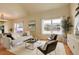 Bright living room with large windows, modern furniture, and hardwood floors at 15555 E 40Th Ave # 30, Denver, CO 80239
