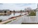 Picturesque water view overlooking a tranquil lake from behind a white fence at 15555 E 40Th Ave # 30, Denver, CO 80239