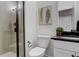 Modern bathroom with a glass enclosed shower, white toilet, and vanity with a dark countertop at 6506 Merrimack Dr, Castle Pines, CO 80108