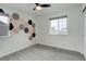 Bedroom with a geometric accent wall, carpet floors, and a bright window at 6506 Merrimack Dr, Castle Pines, CO 80108