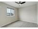 Bright bedroom with a large window offering natural light and a modern ceiling fan at 6506 Merrimack Dr, Castle Pines, CO 80108