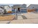 Charming two-story home with stone accents, a covered porch, a well-manicured lawn, and a driveway at 6506 Merrimack Dr, Castle Pines, CO 80108
