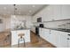 Modern kitchen featuring granite countertops, white cabinets, stainless steel appliances, and hardwood flooring at 6506 Merrimack Dr, Castle Pines, CO 80108