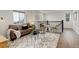 Upstairs living room featuring a comfortable sofa, coffee tables, and a bright open layout at 6506 Merrimack Dr, Castle Pines, CO 80108