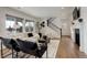 Cozy living room featuring a fireplace, comfortable seating, and large windows for natural light at 6506 Merrimack Dr, Castle Pines, CO 80108