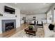 Inviting living room featuring a fireplace, modern decor, and an open floor plan with hardwood floors at 6506 Merrimack Dr, Castle Pines, CO 80108