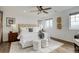 Cozy main bedroom with wood floors, a large window, and a comfortable bed with white linens at 6506 Merrimack Dr, Castle Pines, CO 80108