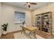 Home office featuring a built-in shelving unit, hardwood floors, and a large window for natural light at 6506 Merrimack Dr, Castle Pines, CO 80108