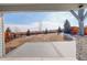 View from the covered outdoor patio showing a wooden fence in the background at 6506 Merrimack Dr, Castle Pines, CO 80108