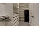 Spacious walk-in closet with custom shelving and storage solutions, including drawers and hanging rods at 6506 Merrimack Dr, Castle Pines, CO 80108