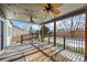 Covered patio with ceiling fans and string lights, overlooking fenced backyard at 388 English Sparrow Trl, Highlands Ranch, CO 80129