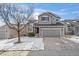 Two-story house with gray siding, red accents, and a two-car garage at 388 English Sparrow Trl, Highlands Ranch, CO 80129