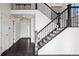 Elegant staircase with dark metal railing and dark hardwood floors at 388 English Sparrow Trl, Highlands Ranch, CO 80129