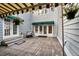 Exterior shot of the house with a covered porch and mature trees at 4505 S Yosemite St # 125, Denver, CO 80237