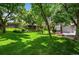 Large backyard with lush green grass and mature trees at 4505 S Yosemite St # 125, Denver, CO 80237