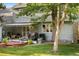 Exterior shot of the house with a covered porch and mature trees at 4505 S Yosemite St # 125, Denver, CO 80237