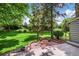 Backyard with a wooden deck, patio, manicured lawn, and mature trees at 4505 S Yosemite St # 125, Denver, CO 80237