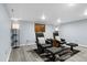 Finished basement with gray walls and flooring, two recliners, and modern lighting at 4505 S Yosemite St # 125, Denver, CO 80237