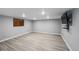 Spacious basement area with wood-look flooring and a wall-mounted television at 4505 S Yosemite St # 125, Denver, CO 80237