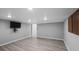 A view of the basement with wood-look flooring and a wall-mounted television at 4505 S Yosemite St # 125, Denver, CO 80237