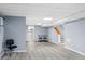 Basement with light gray walls and flooring, featuring a staircase and dining area at 4505 S Yosemite St # 125, Denver, CO 80237