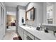 Bathroom with a long vanity, storage, and access to additional rooms at 4505 S Yosemite St # 125, Denver, CO 80237