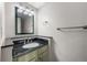 Bathroom featuring a vanity with a dark countertop and an oval sink at 4505 S Yosemite St # 125, Denver, CO 80237