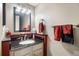 Bathroom with dark countertops, wood accents, a mirror and towel racks at 4505 S Yosemite St # 125, Denver, CO 80237