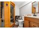 Bathroom featuring a sauna, toilet, and vanity with wood cabinets and granite counters at 4505 S Yosemite St # 125, Denver, CO 80237