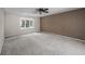 Spacious bedroom featuring a ceiling fan, neutral carpet and window at 4505 S Yosemite St # 125, Denver, CO 80237