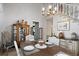 Formal dining room featuring a chandelier and stylish furnishings with staircase in background at 4505 S Yosemite St # 125, Denver, CO 80237