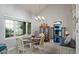 Dining room featuring a chandelier, large window, and access to the kitchen at 4505 S Yosemite St # 125, Denver, CO 80237