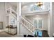 Bright entryway with staircase, white railings, and a stylish console table at 4505 S Yosemite St # 125, Denver, CO 80237