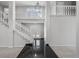 Grand foyer with a staircase, chandelier, balcony, and dark tile entryway, leading to the home's interior at 4505 S Yosemite St # 125, Denver, CO 80237