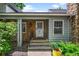 Charming front porch with stone accents, a decorative security door, and well-maintained landscaping at 4505 S Yosemite St # 125, Denver, CO 80237
