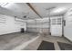Spacious two car garage with overhead storage, shelving, and ample room for vehicles and storage at 4505 S Yosemite St # 125, Denver, CO 80237