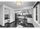 Bright kitchen features glossy black tile floors, granite countertops, modern appliances, and plenty of cabinet space at 4505 S Yosemite St # 125, Denver, CO 80237